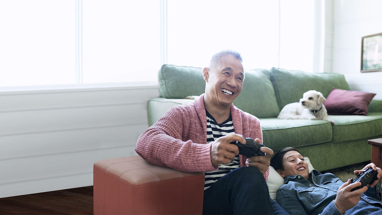 Grandfather and grandson playing video games at home; image used for HSBC Singapore Life Retirement Income.