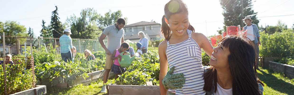 Adults and children doing gardening; image used for HSBC Singapore charity rewards.