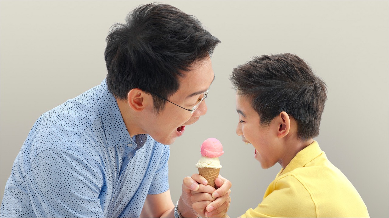 Father and son eating ice cream
